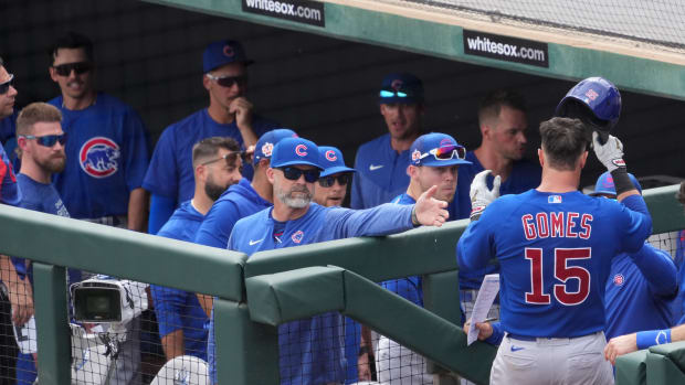 Mar 11, 2023; Phoenix, Arizona, USA; Chicago Cubs catcher Yan Gomes (15) celebrates with Chicago Cubs manager David Ross (3) and teammatesafter hitting a home run against the Los Angeles Dodgers during the fifth inning at Camelback Ranch-Glendale. Mandatory Credit: Joe Camporeale-USA TODAY Sports